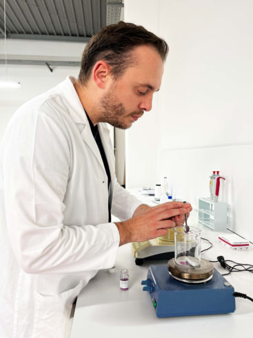 Product developer makes a preparation with an exotic powder extract in the lab